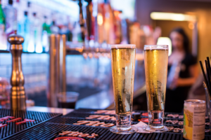 chilled beers in glasses on bar - Gulp Playa Vista